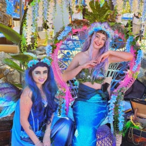 A mermaid performer and a fairy performer posing at a corporate event for WA mermaids
