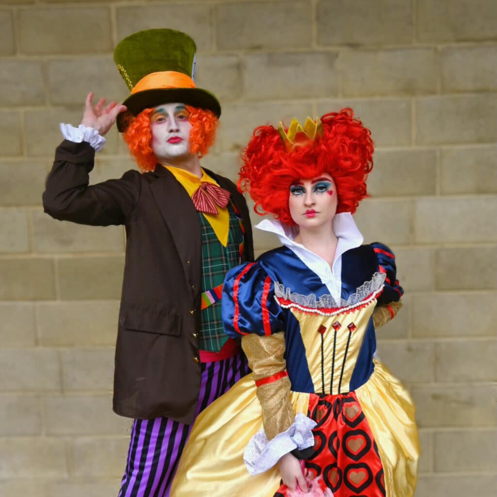 Mad Hatter performer & Queen of Hearts performer posing