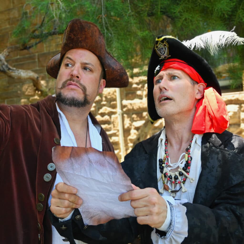 two pirates looking at a treasure map at a children's party